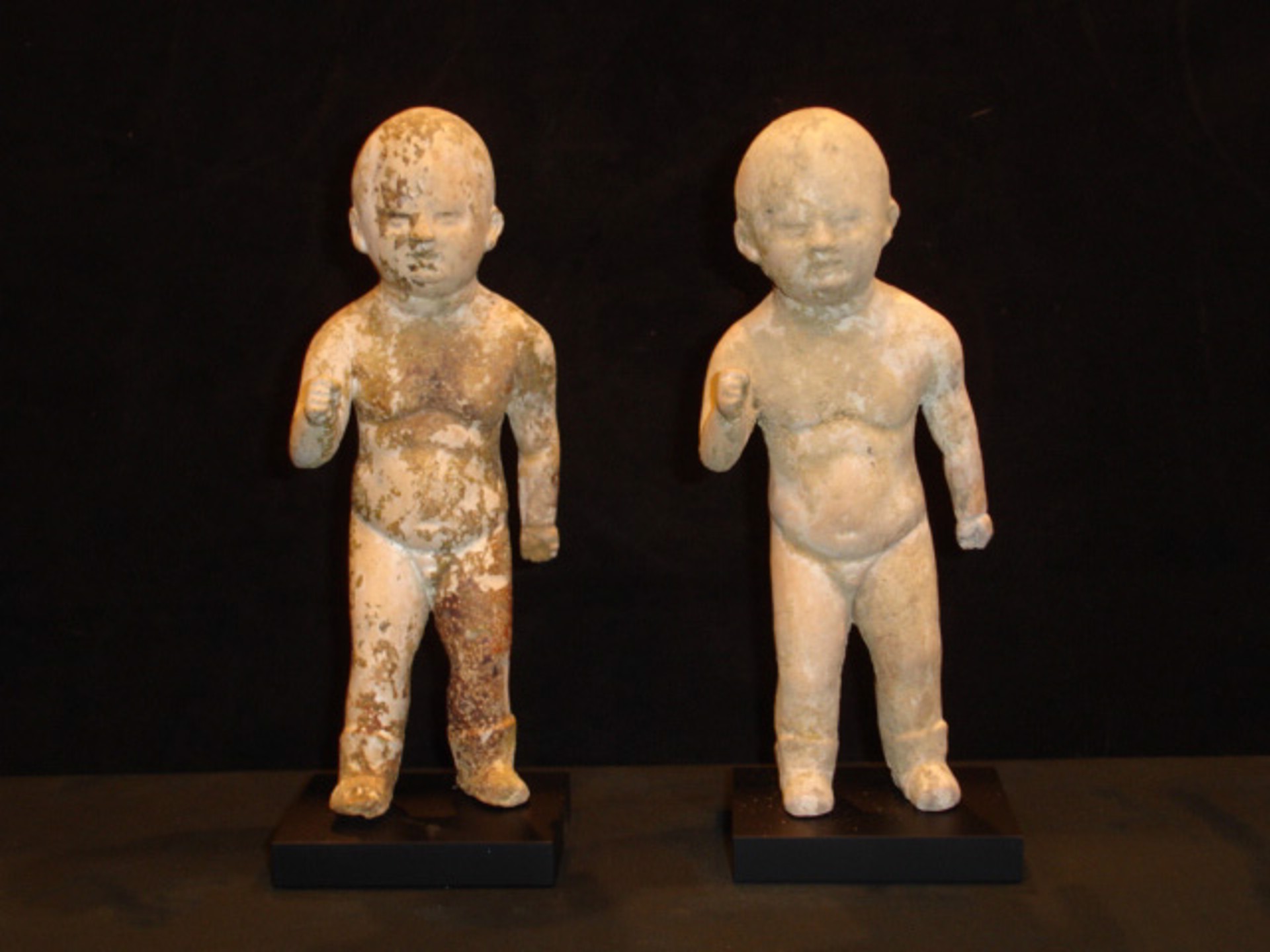 TWO SMALL PAINTED POTTERY FIGURES OF CHILDREN