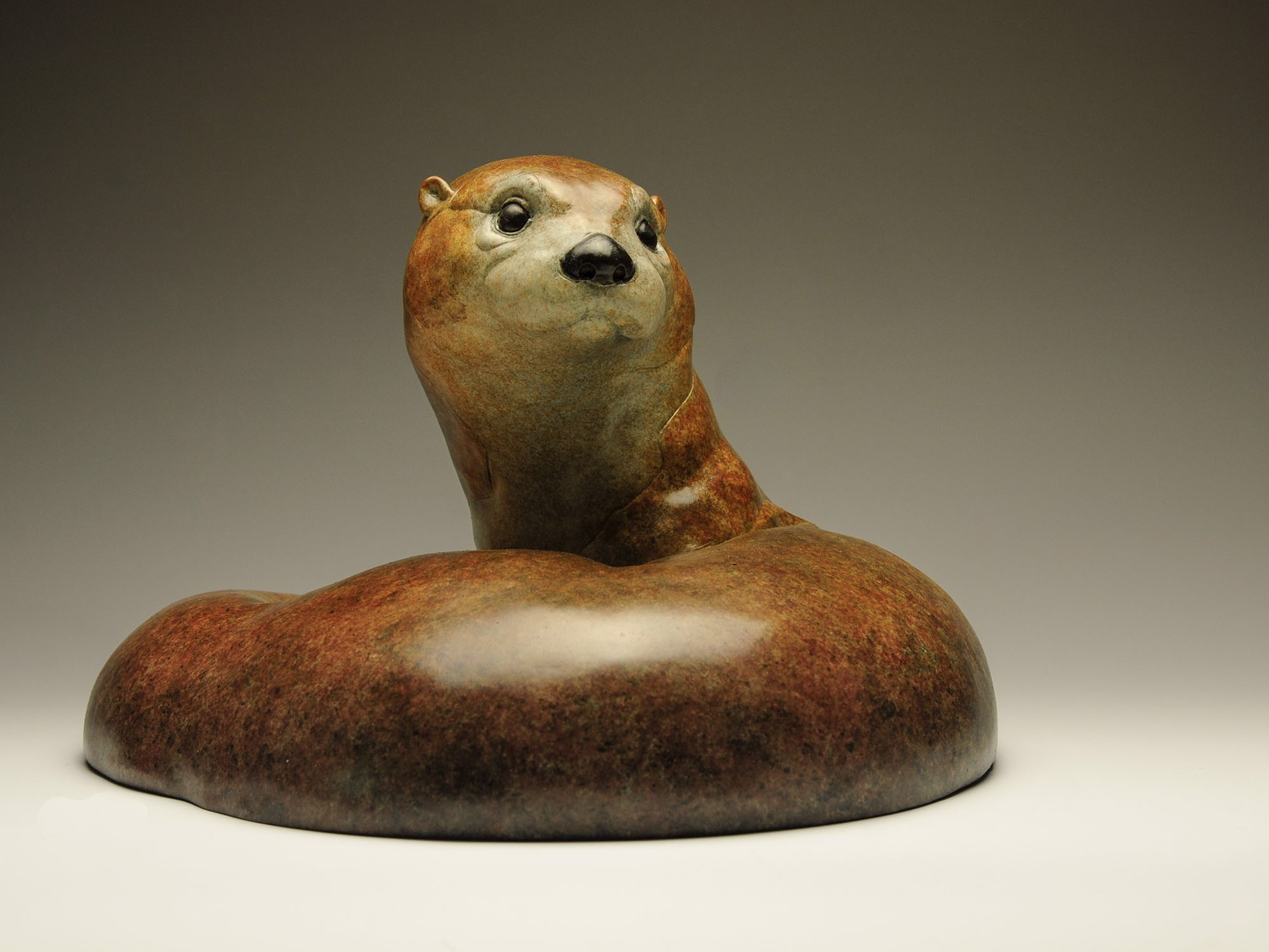 A Bronze Sculpture Of An Otter Curled Up In A Circle Featuring A Contemporary Patina And Smooth Surface, By Jeremy Bradshaw, Available At Gallery Wild
