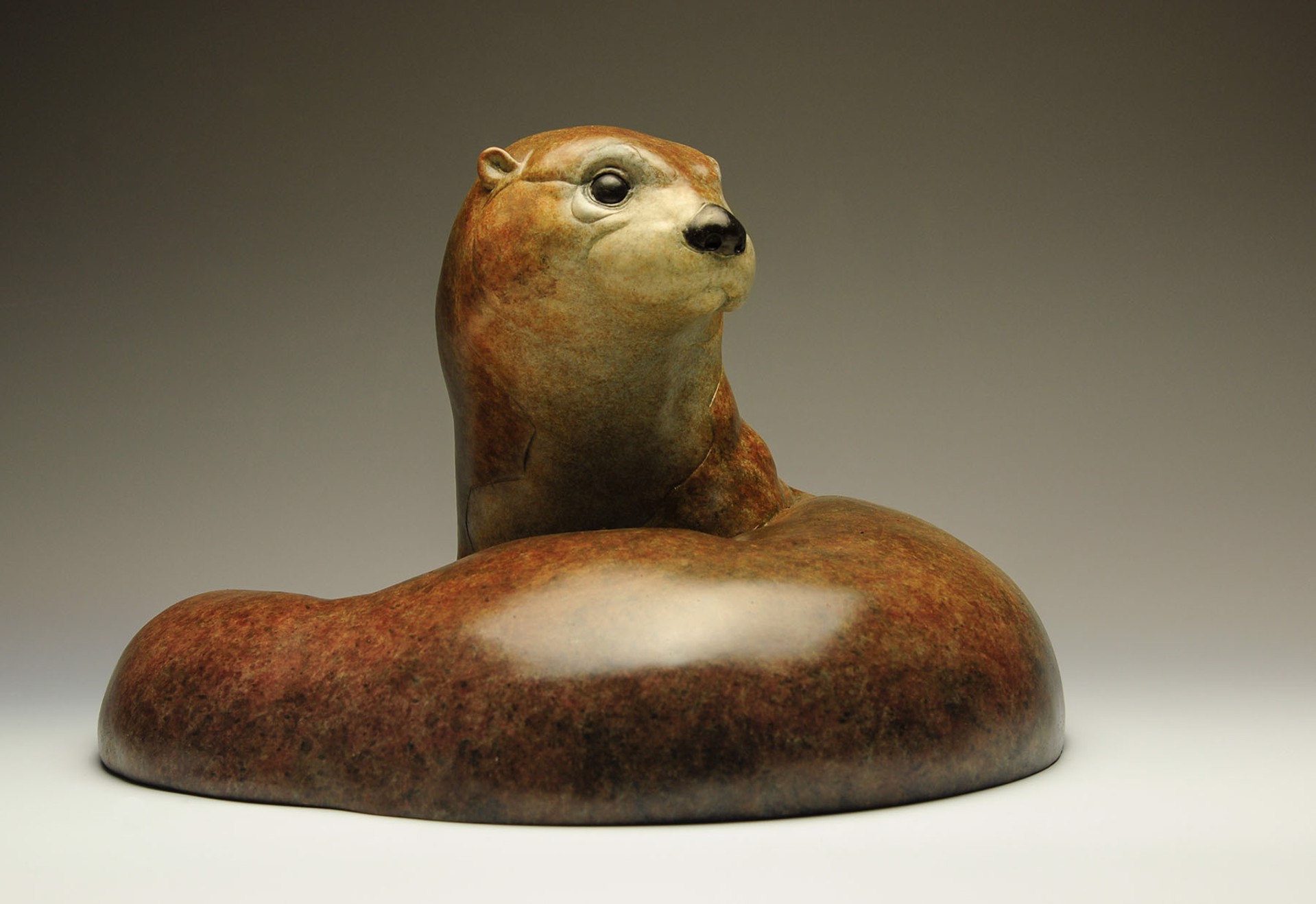 A Bronze Sculpture Of An Otter Curled Up In A Circle Featuring A Contemporary Patina And Smooth Surface, By Jeremy Bradshaw, Available At Gallery Wild