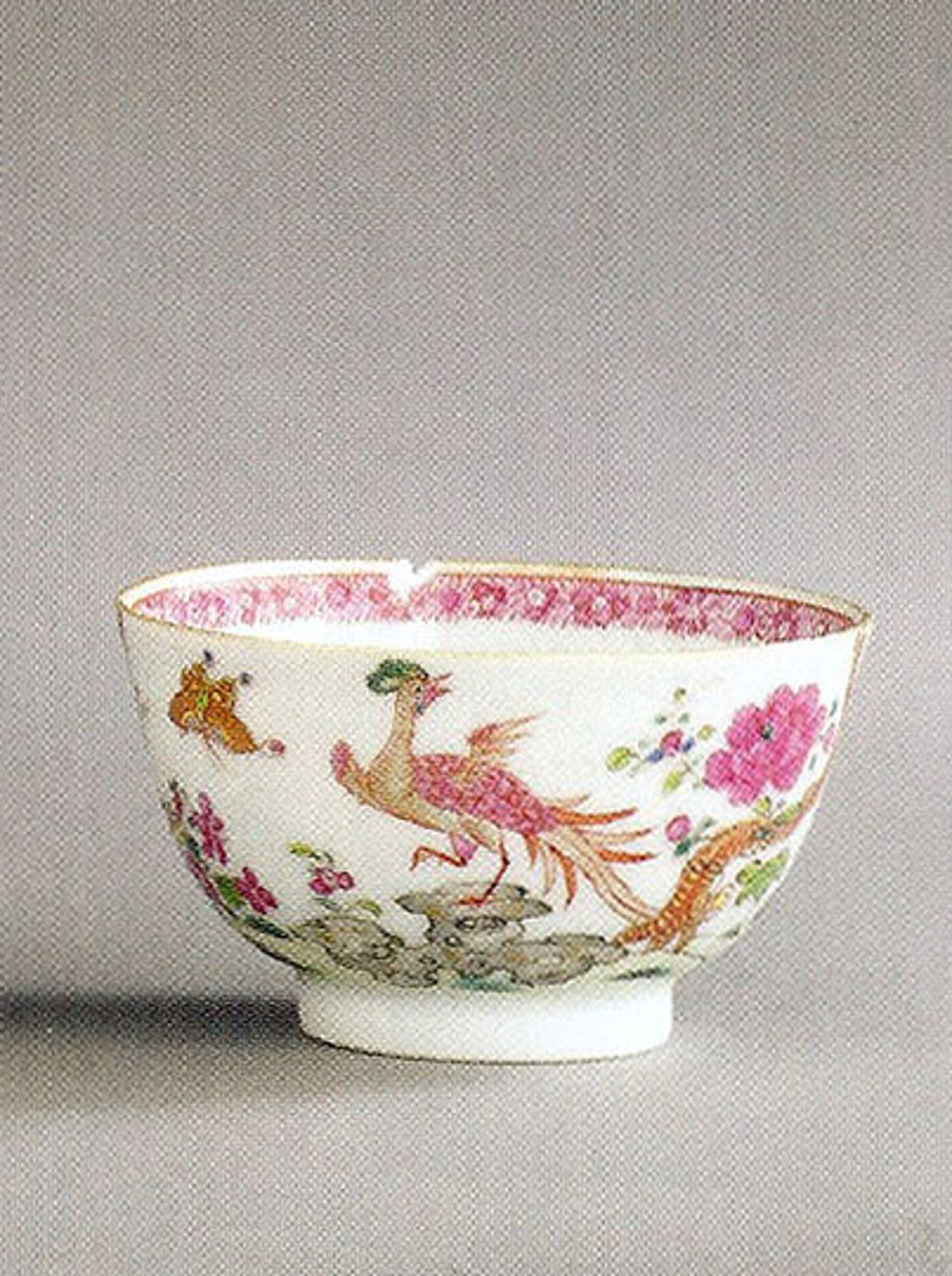 CHINESE EXPORT TEABOWL WITH EXOTIC BIRD, FLOWERING ROCKS AND BUTTERFLY