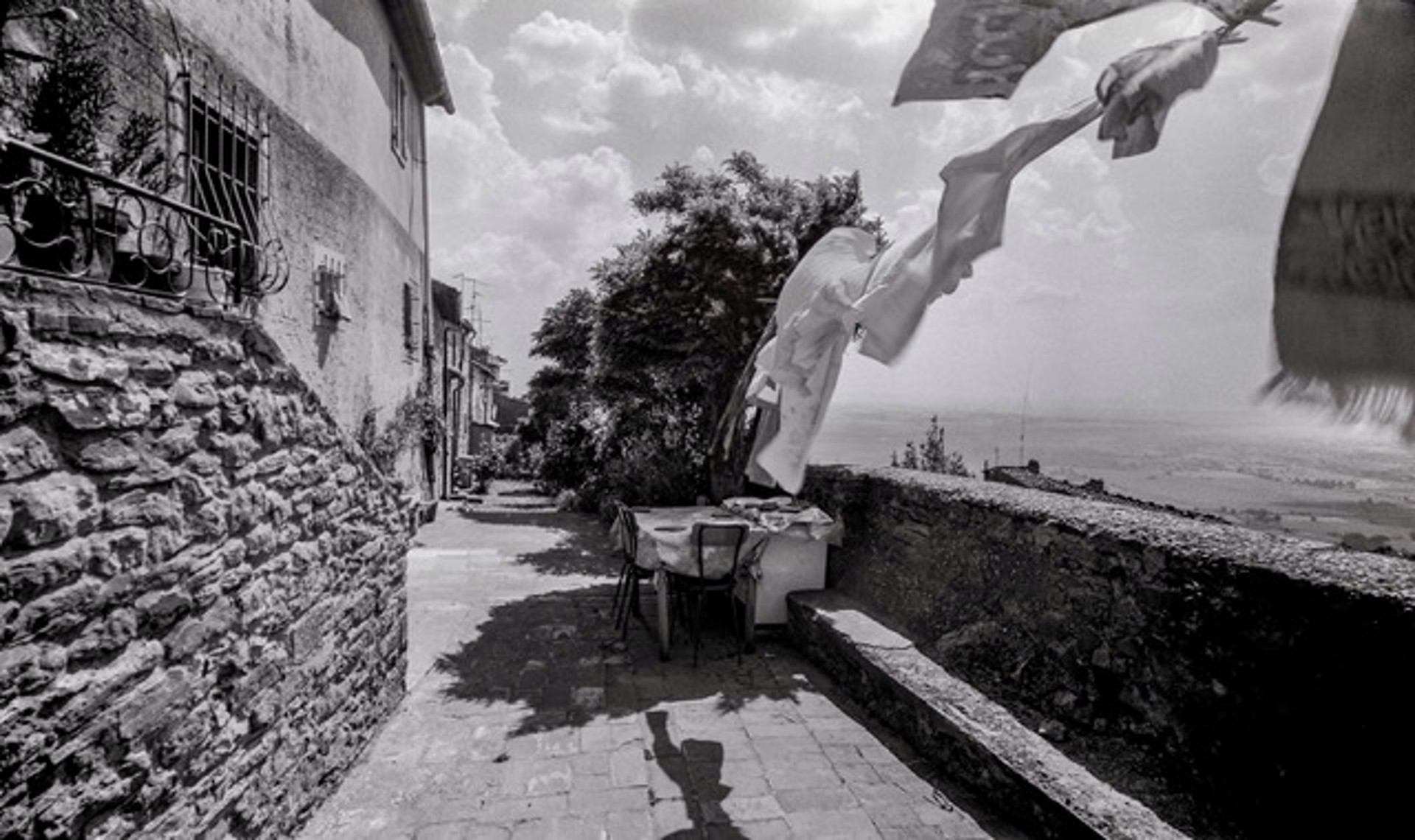 The Alleyway, Dinner Table and Cloths Drying on the Line, Cortona, Italy by Lawrence McFarland