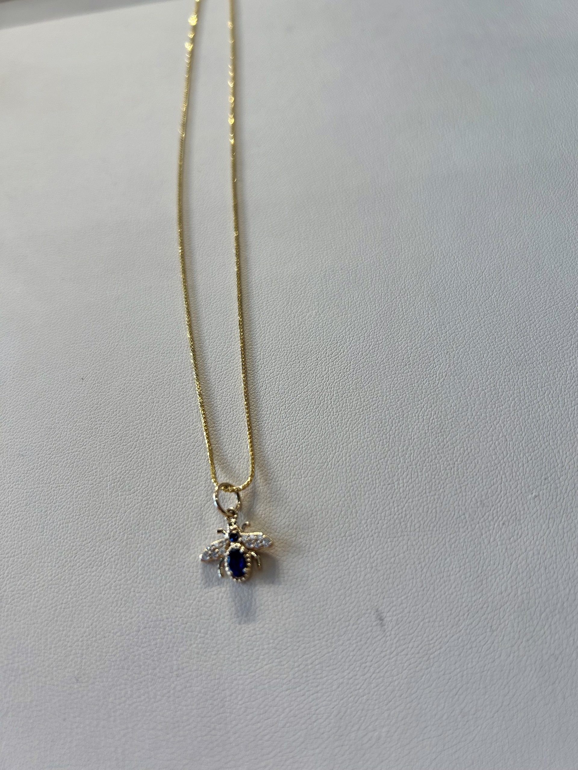 KB-N26 14k gold necklace with a gold diamond and blue sapphire Bee pendant by Karen Birchmier