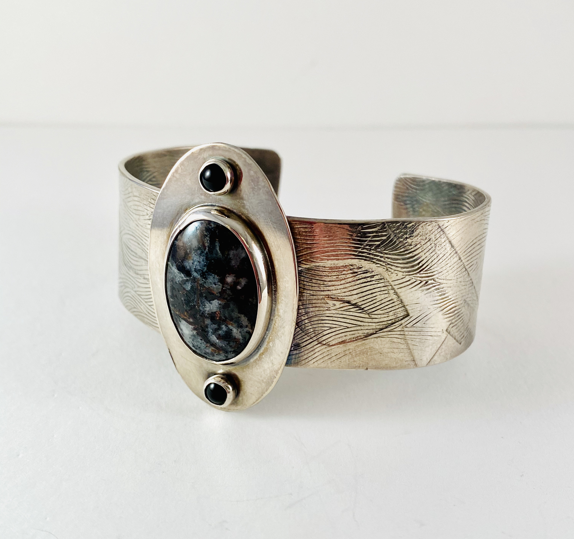 Hand Textured Sterling Cuff with Russian Astrophyllite center stone, Onyx accents by Anne Bivens