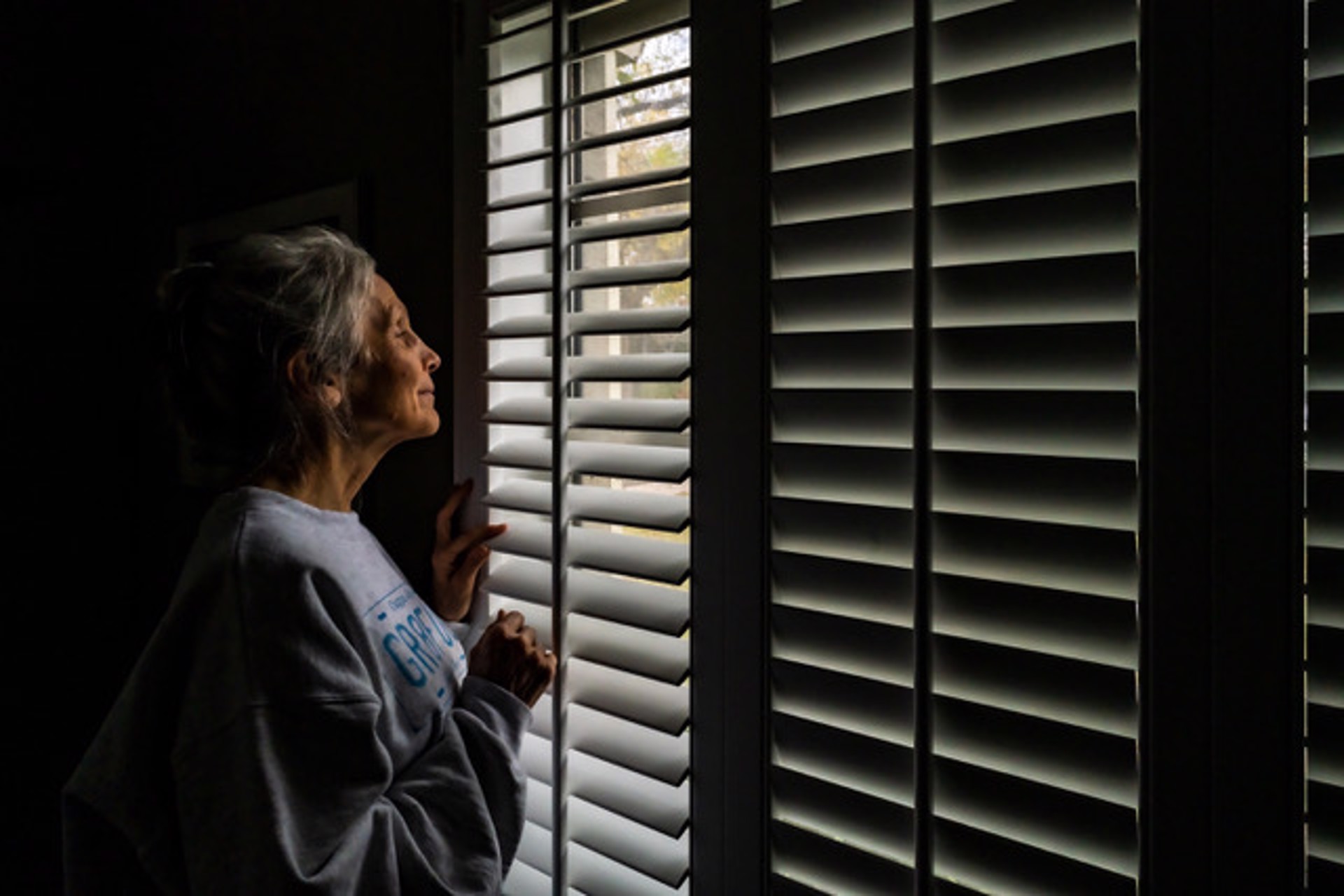 From Around the House During the Pandemic, Grace Looking out the Front Window in Beautiful Light, Texas by Lawrence McFarland
