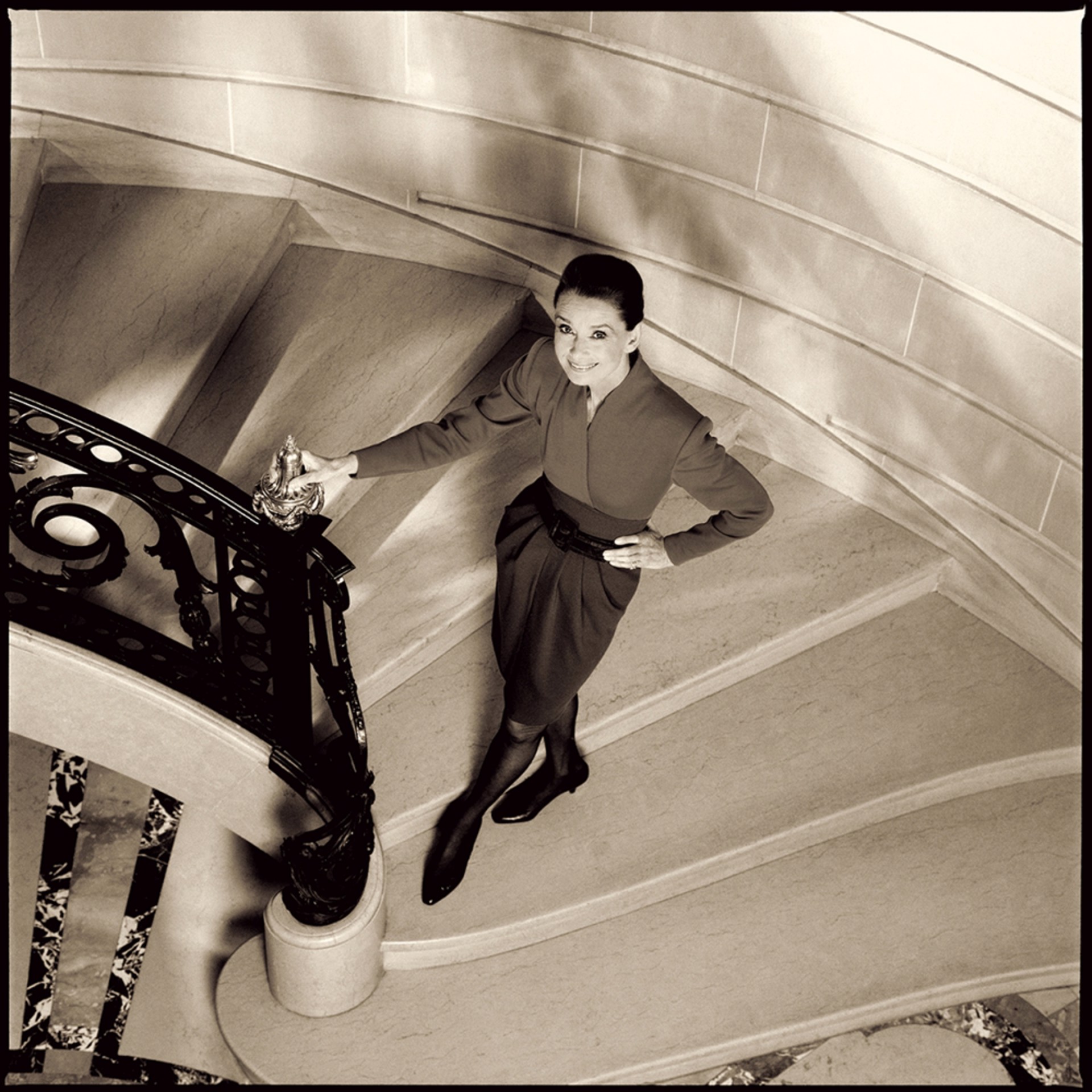 89003 Audrey Hepburn Smiling in Stairway Sepia by Timothy White