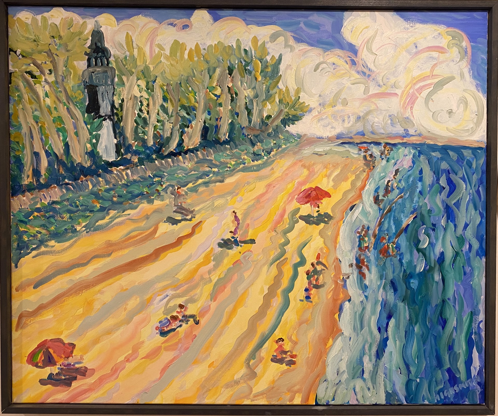 large beach scene with forest, water, and beach and beachgoers