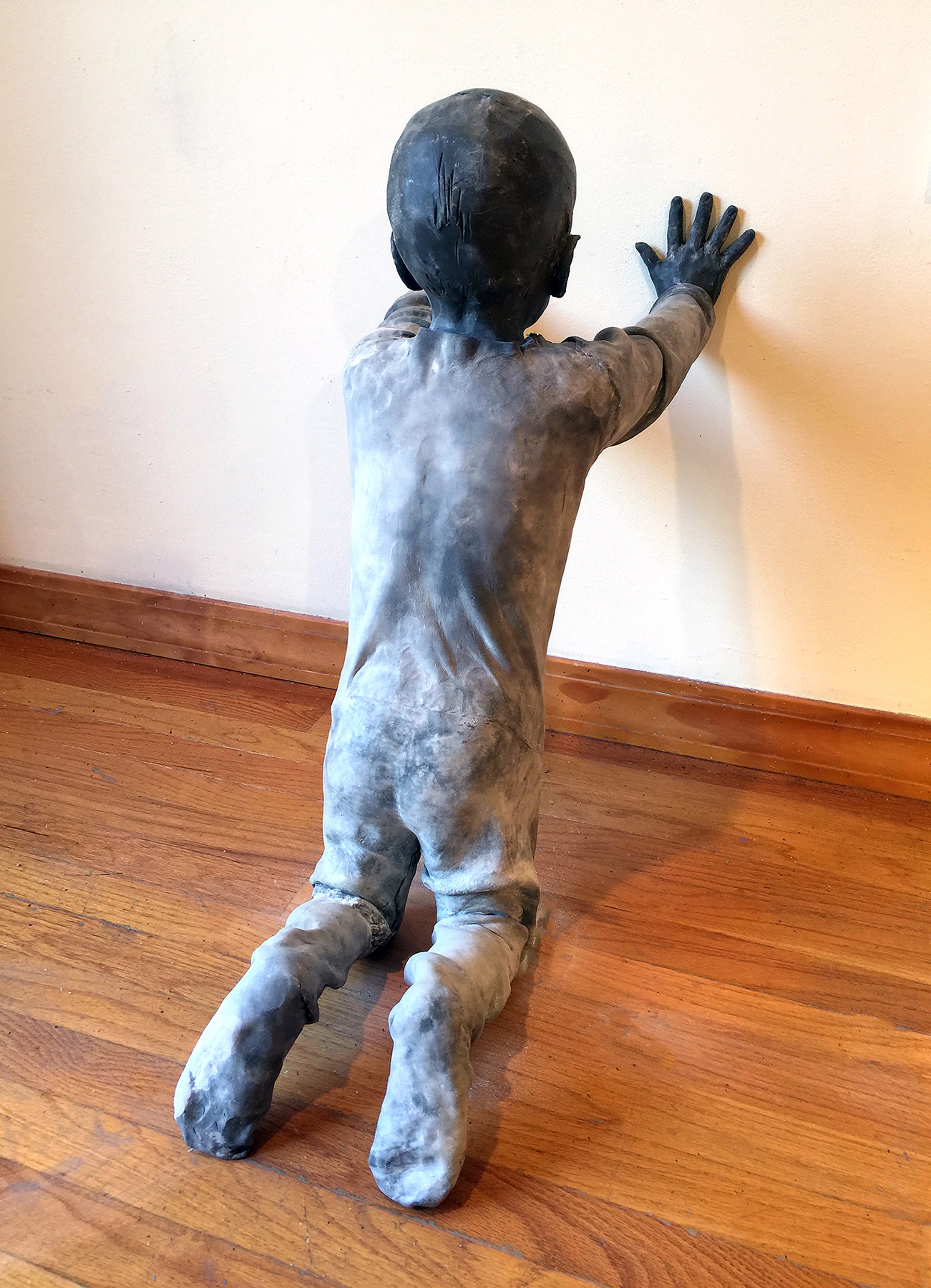 Figure of a Child Kneeling and Leaning on the Wall by Jose Cobo