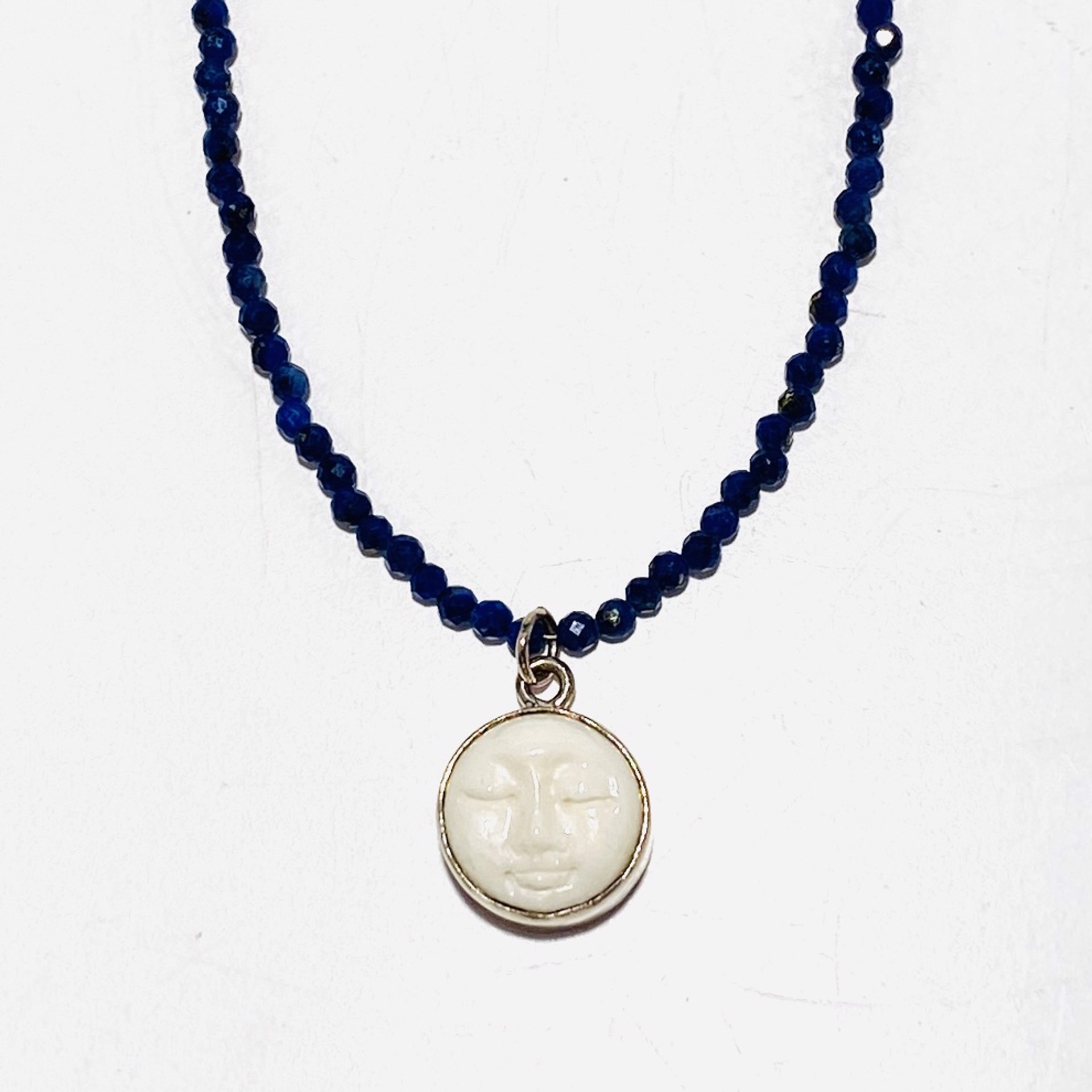 Tiny Faceted Lapis  Carved Bone Moon Face Charm Necklace by Nance Trueworthy