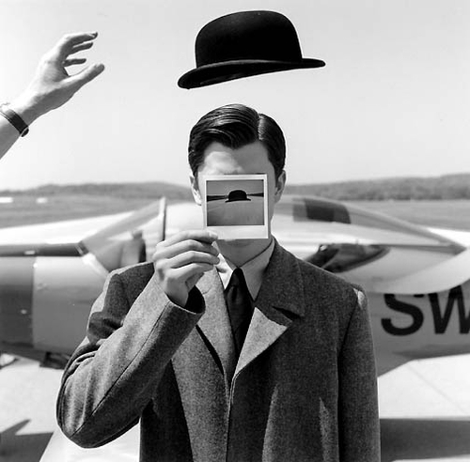 Wyatt Holding Polaroid in Front of Face, Orange County Airport, NY, 1998 by Rodney Smith | ArtCloud