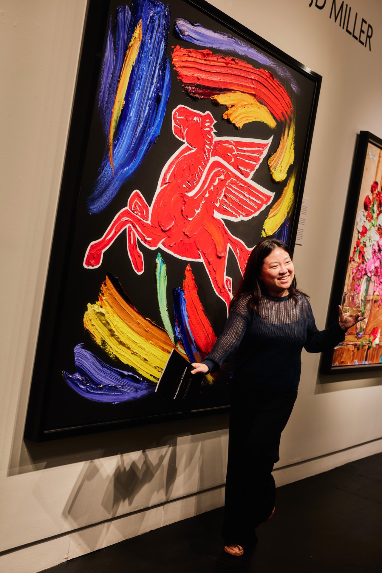 A guest beside JD Miller's Project Pegasus on opening night of the Reflectionist Exhibition