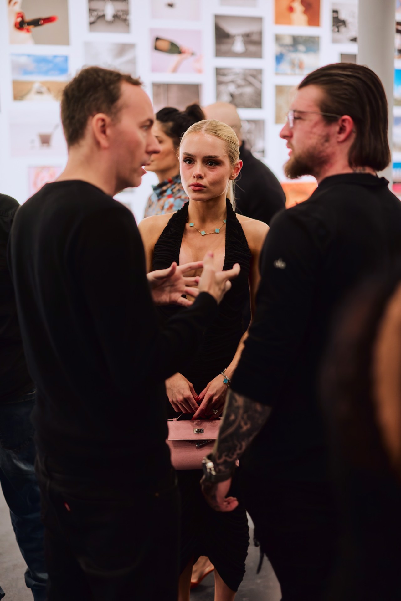 Guests in front of the wall of pages from Tyler Shields' The Book at Samuel Lynne Galleries