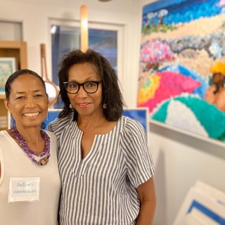 Zita Cousens, left, and Rehema Ellis with a Glenn Tunstull oil painting in the background. —Courtesy Cousen Rose Gallery