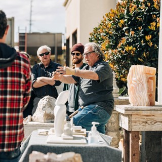 Steven Lustig and his assistant Nathan Wiederman with his orange calcite sculpture Steven Lustig and his assistant Nathan Wiederman with his orange calcite sculpture