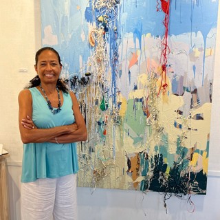 Zita Cousens at the gallery with a mixed-media piece by David Schuster. —Courtesy Cousen Rose Gallery