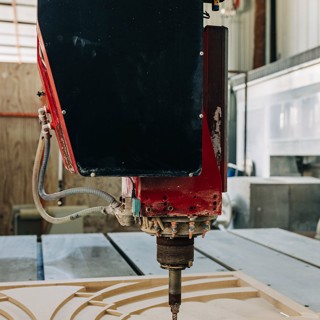 CNC machine carving an art deco stone wall cap for a Chiarini client CNC machine carving an art deco stone wall cap for a Chiarini client