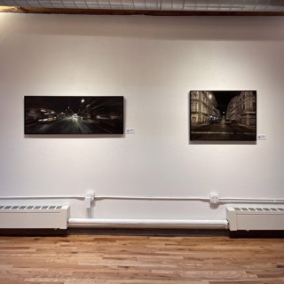 Continue the nocturnal journey with two more cityscape paintings. The piece on the left embodies D'Ospina's signature motion technique, while the right offers a more tranquil perspective. Both pieces enhance the diverse visual experience in this solo exhibition at Gallery 1261. Continue the nocturnal journey with two more cityscape paintings. The piece on the left embodies D'Ospina's signature motion technique, while the right offers a more tranquil perspective. Both pieces enhance the diverse visual experience in this solo exhibition at Gallery 1261.