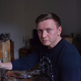 Portrait of fine artist Serge Marshennikov in his studio, looking intently toward the camera with a contemplative expression. He wears a dark, casual long-sleeve shirt, and his posture at the easel suggests he is either preparing to work or taking a reflective pause. The subdued lighting and muted background create a focused, intimate atmosphere, drawing attention to his thoughtful demeanor. Known for his highly detailed and elegant figurative paintings, this image captures Marshennikov's seriousness and dedication to his craft, reflecting his meticulous approach to capturing beauty and emotion in his art. Portrait of fine artist Serge Marshennikov in his studio, looking intently toward the camera with a contemplative expression. He wears a dark, casual long-sleeve shirt, and his posture at the easel suggests he is either preparing to work or taking a reflective pause. The subdued lighting and muted background create a focused, intimate atmosphere, drawing attention to his thoughtful demeanor. Known for his highly detailed and elegant figurative paintings, this image captures Marshennikov's seriousness and dedication to his craft, reflecting his meticulous approach to capturing beauty and emotion in his art.