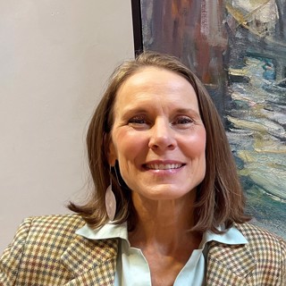 A professional headshot of Rose Fredrick, curator of the Rose Fredrick Project Space. Rose is smiling warmly, wearing a checkered blazer over a light blue collared shirt. She has shoulder-length brown hair and is accessorized with a dangling leaf-shaped earring. The background includes a textured, abstract painting in muted tones, adding a creative and artistic touch to the image. A professional headshot of Rose Fredrick, curator of the Rose Fredrick Project Space. Rose is smiling warmly, wearing a checkered blazer over a light blue collared shirt. She has shoulder-length brown hair and is accessorized with a dangling leaf-shaped earring. The background includes a textured, abstract painting in muted tones, adding a creative and artistic touch to the image.