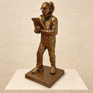 Matthew Snider MARKET SAVANT™ Hand-Painted Bronze-Finish 18-Inch Sculpture: bronze-toned resin figure of Peter Tuchman holding a device, wearing glasses and a chain, on a square base.